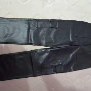 Crne kožne pantalone sa dzepovima