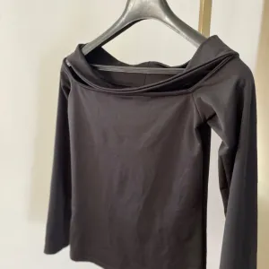 Crna bluza spuštenih ramena