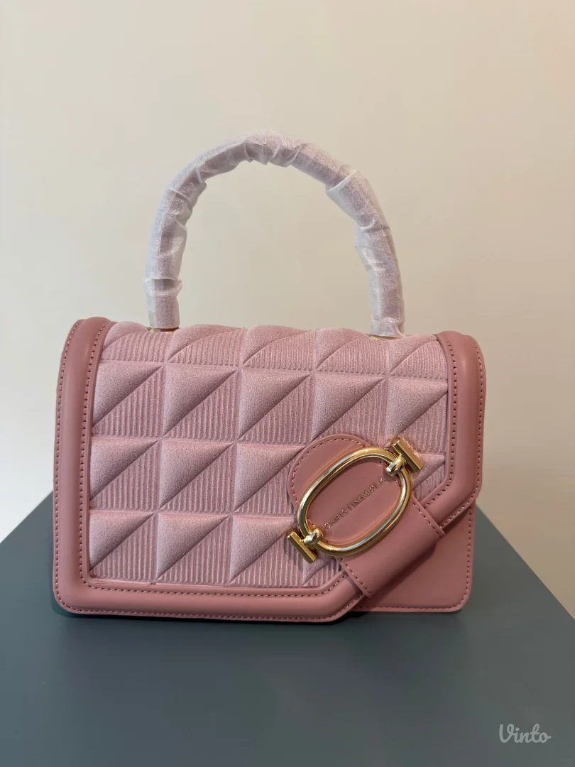 Roze torbica sa zlatnim detaljima