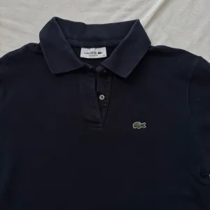 Lacoste teget ženska polo majica (Vel. 38)
