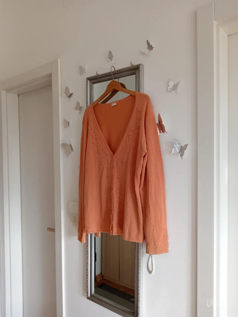 Narandžasti džemper sa radom po sebi