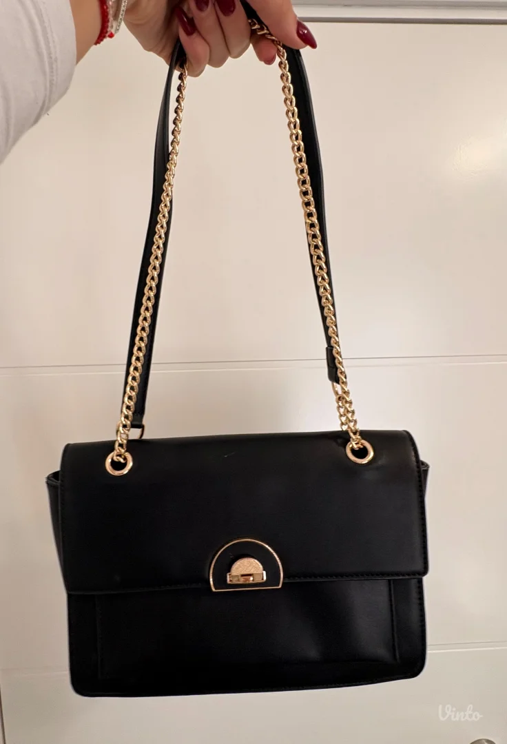 Elegantna crna torbica sa zlatnim detaljima